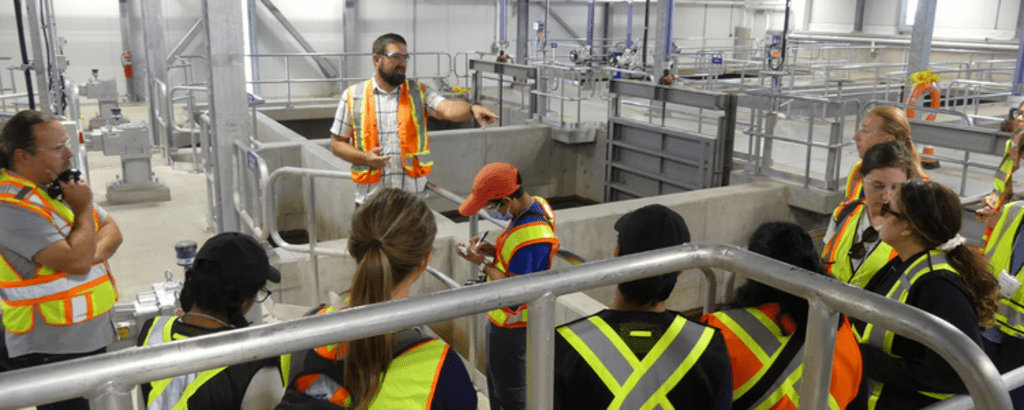 Students listening to a lesson in a water facility
