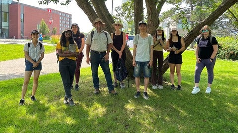 A group of students in front of a tree