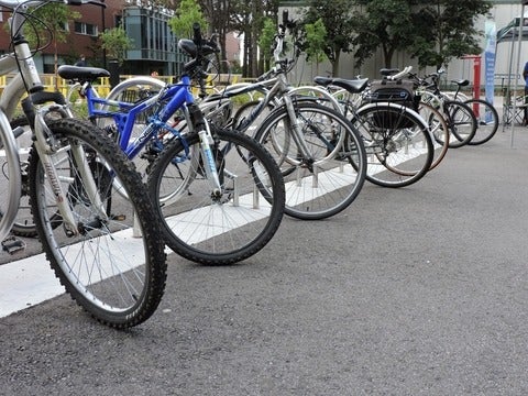 Bikes lined up at the bike racks in front of Dana Porter