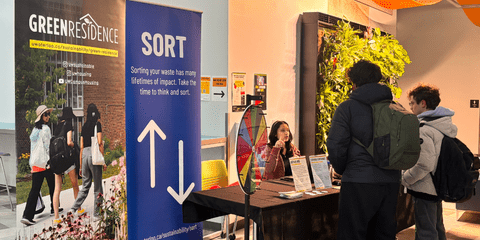 Students talking to Green Residence ambassador at pop-up booth