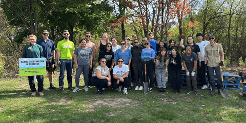 Tree planting volunteers in front of Healing Forest
