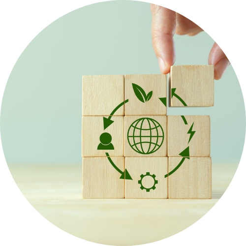 Nine wooden blocks stacked in 3x3 grid with green icons symbolizing circular economy