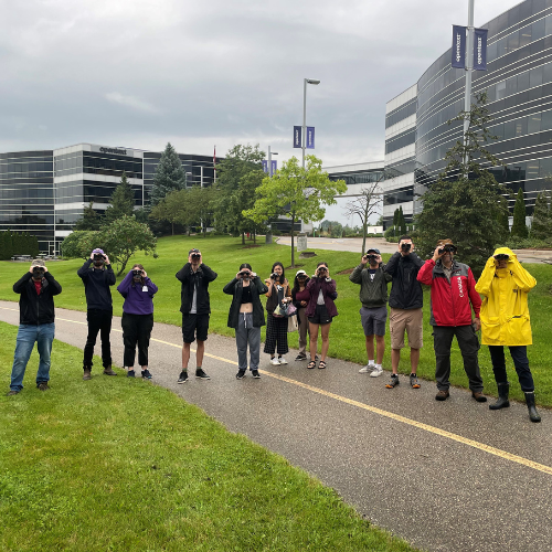 Students looking through binoculars