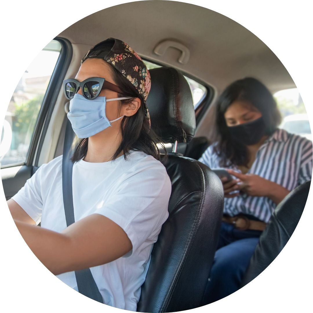 Two people carpooling with masks on