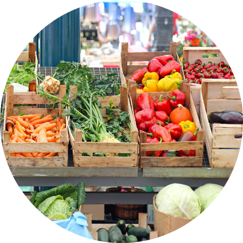 Assortment of fresh produce in wooden crates at community farm market