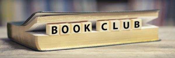 Book lying flat with Scrabble letters in spine spelling "book club"