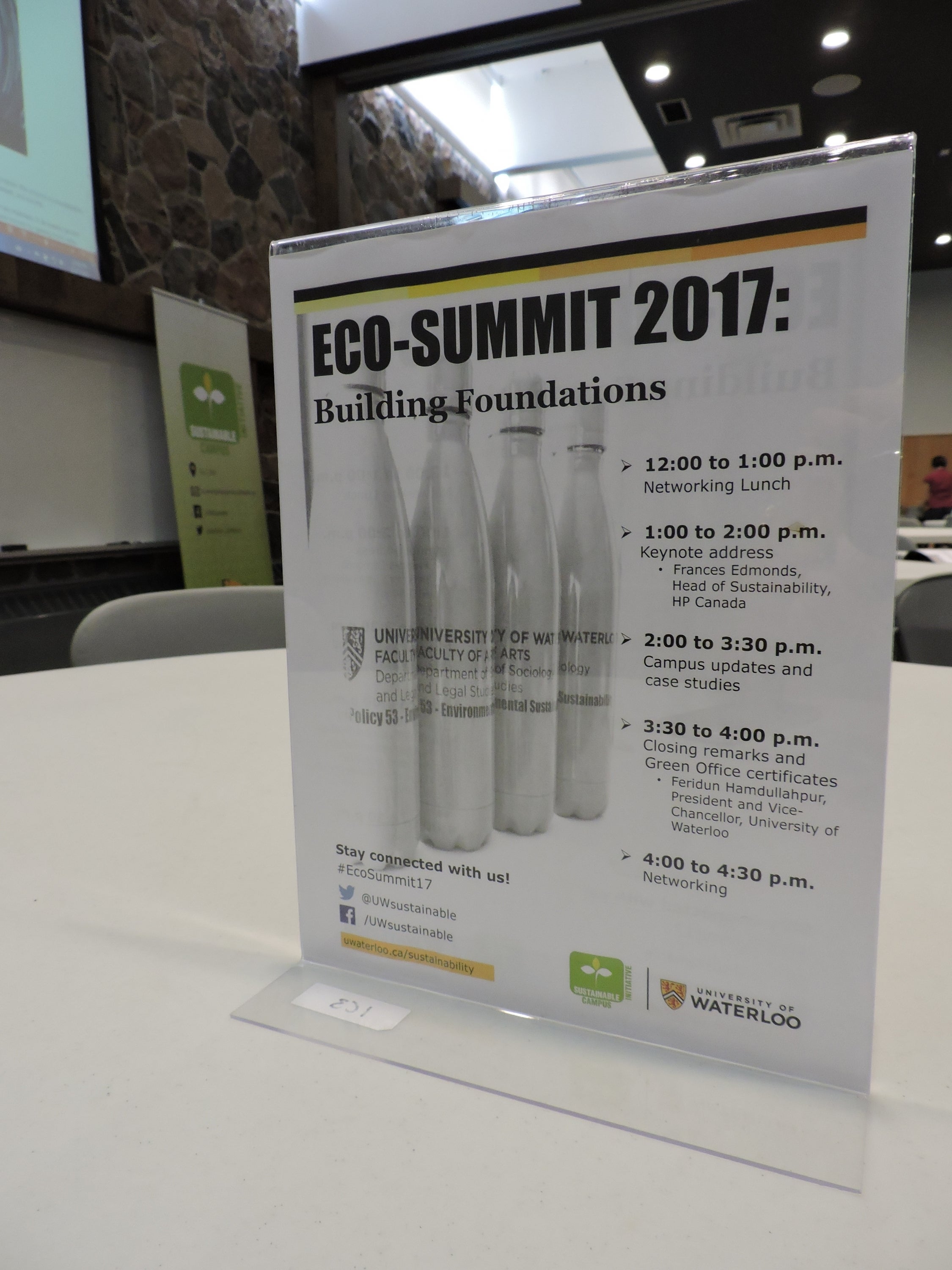 Eco-Summit poster on the table that outlines the day's agenda
