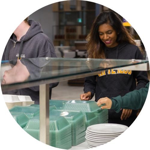 Students grabbing eco container in residence caf
