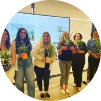 Green Office employees with newly potted plants