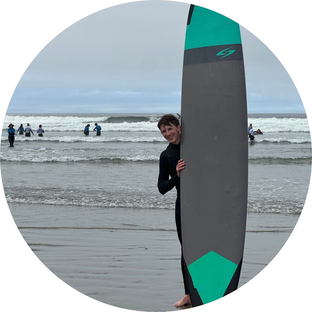 Sam with a surf board