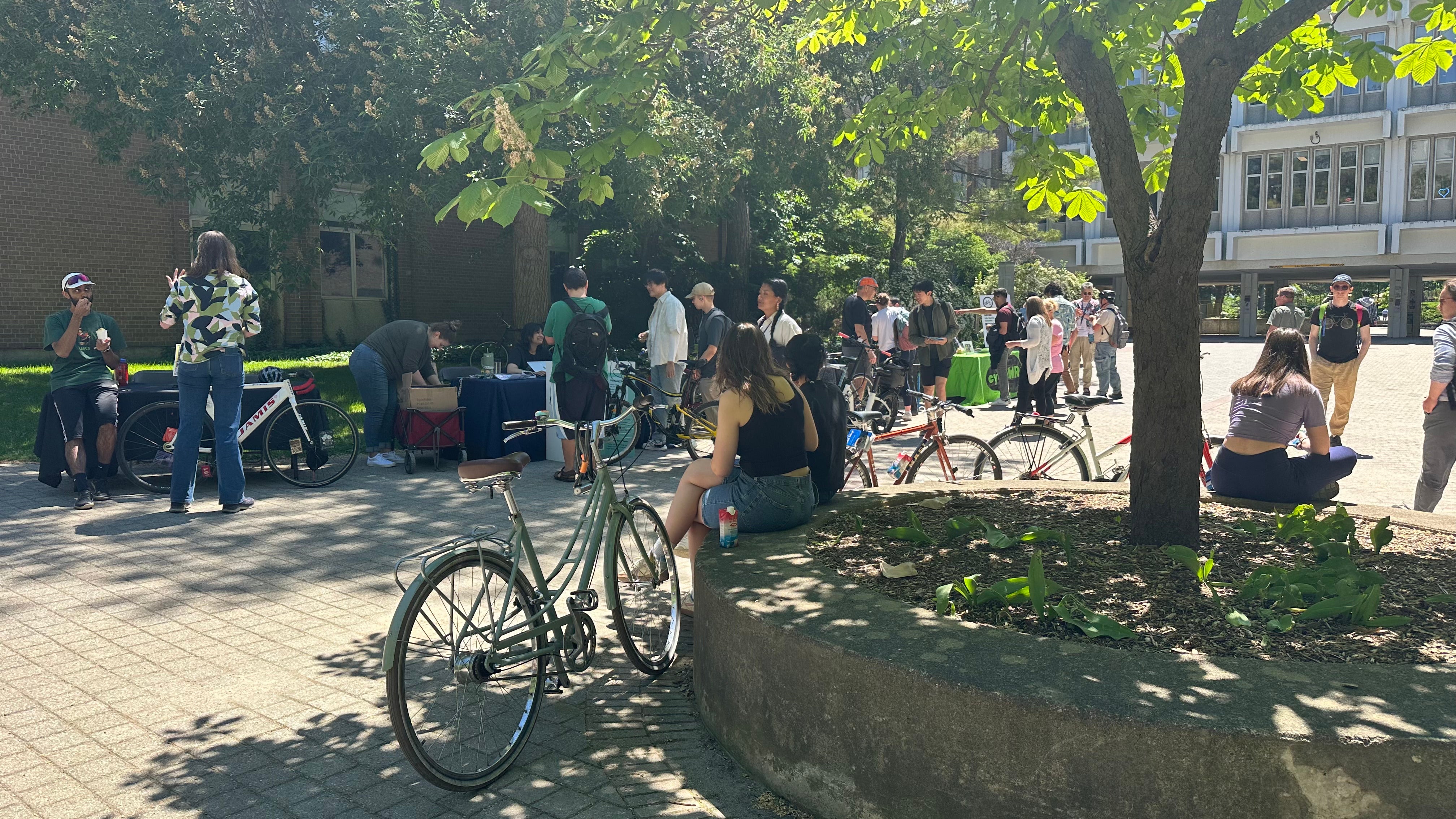 people with bikes on campus sitting on ledge