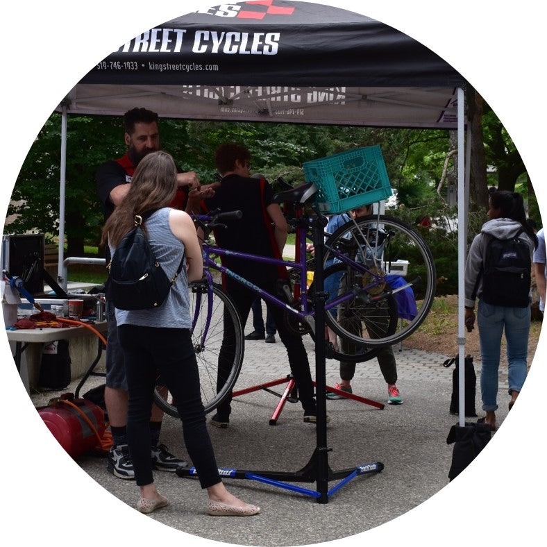 King Street Cycles staff doing bike tuneups at bike lunch 2018 event