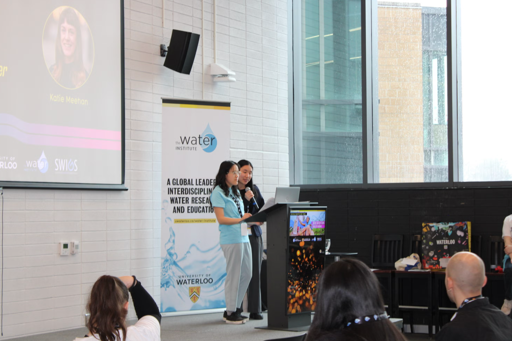 Two presenters standing at the podium