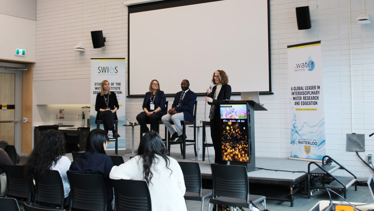 Pane with four panelists sitting on stage 