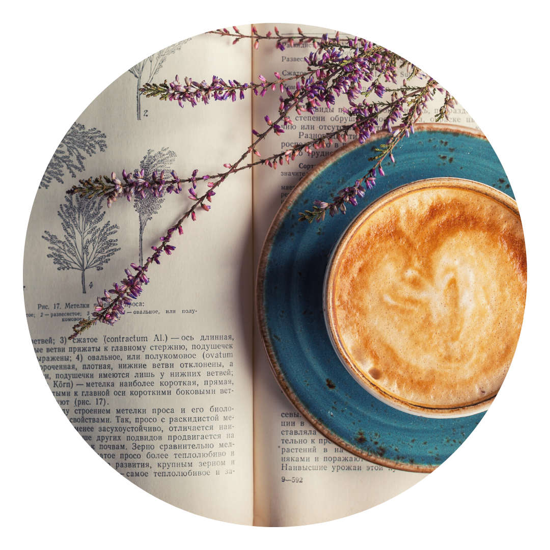 Book with some dried lavender and a cappucino with a heart on top