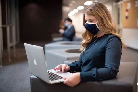 Student wearing mask on laptop