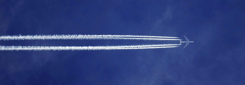 Plane with contrails