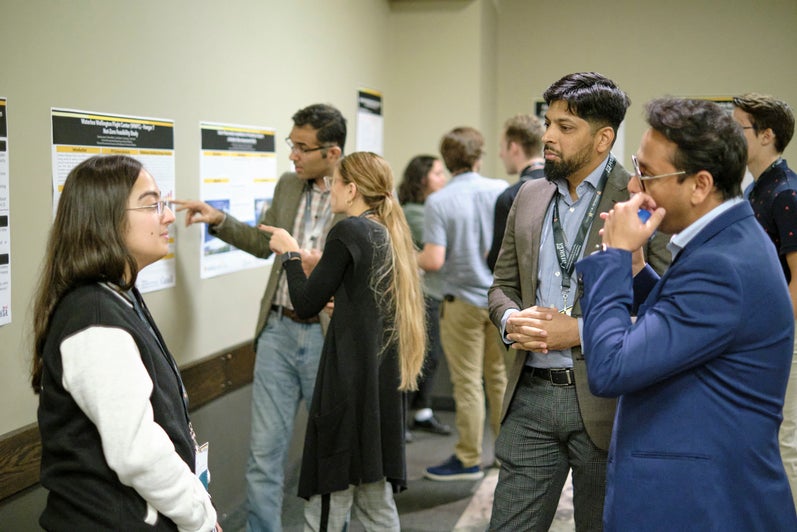 Participants networking and discussing the posters at the Summit