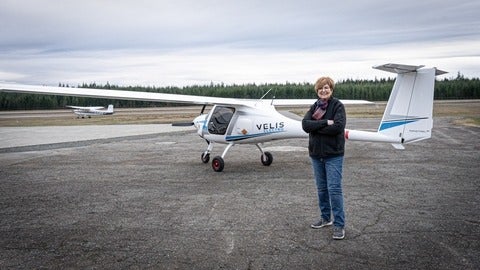 A woman standing in front of the Pipistrel 