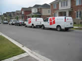 Vans in front of houses