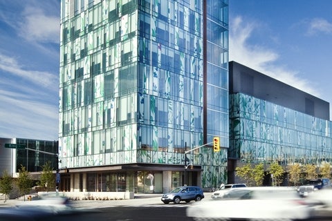 Kitchener's Pharmacy building with cars driving past