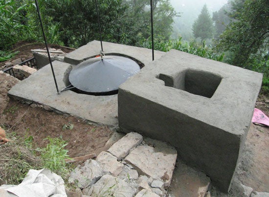a concrete structure in wilderness with metal cover