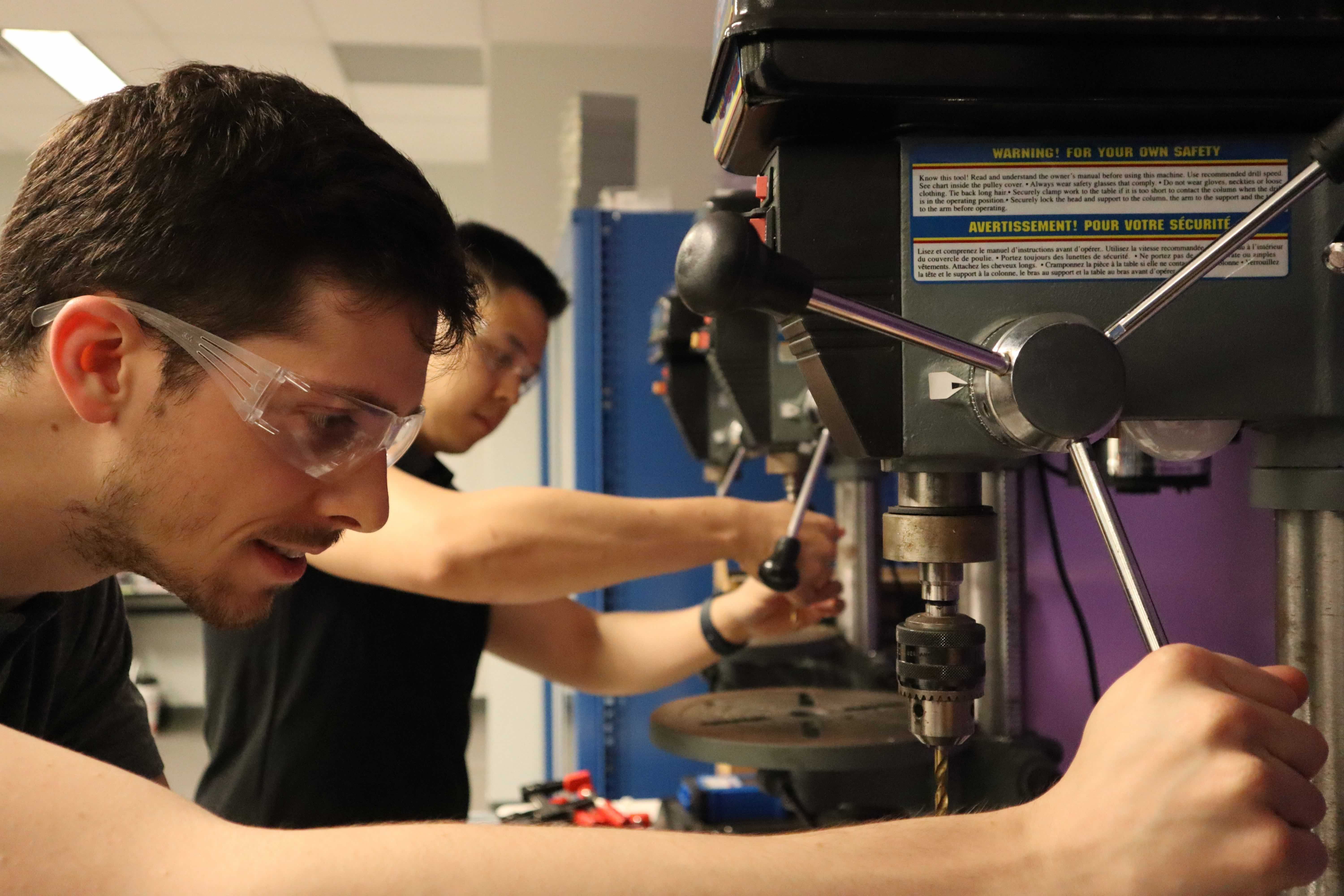 Grad student using a drill press