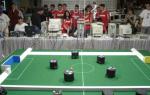 mini robots on a mini soccer soccer fieid