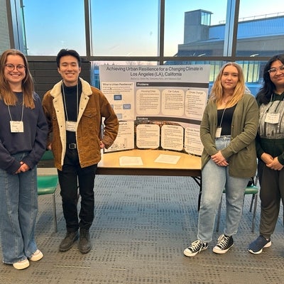 Undergraduate students with their poster