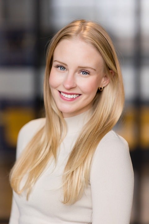 professional headshot of woman with blonde hair and blue eyes.