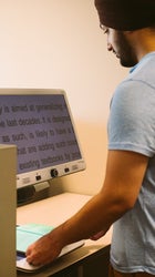man reading text from an accessibility reader