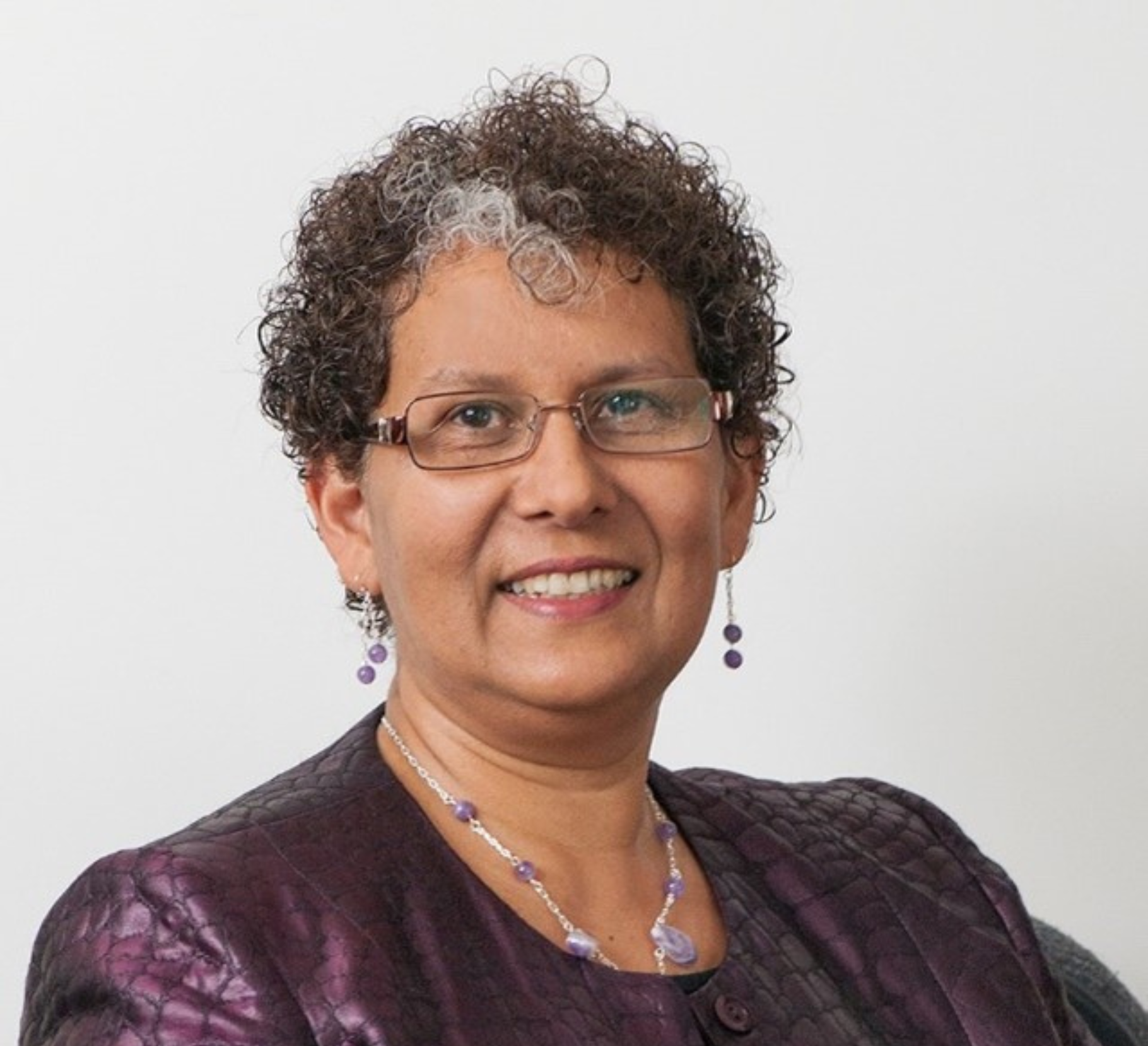 A professional headshot of Charmaine Dean