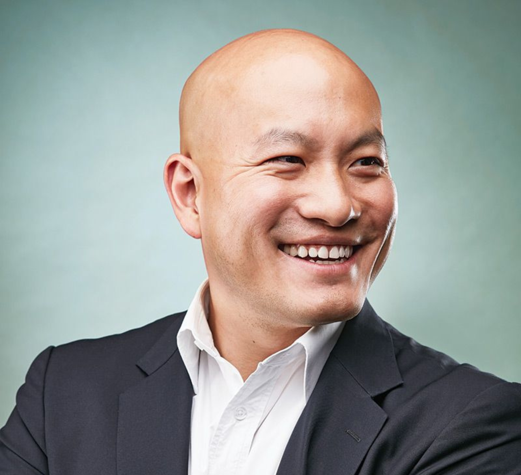 A professional headshot of Wehuns Tan