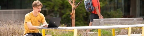 Student working on a computer outside