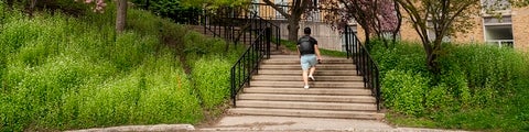 Student walking up steps