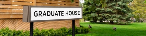 Graduate house sign with 2 geese in the background