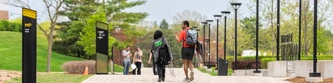 Students walking along the main path of campus