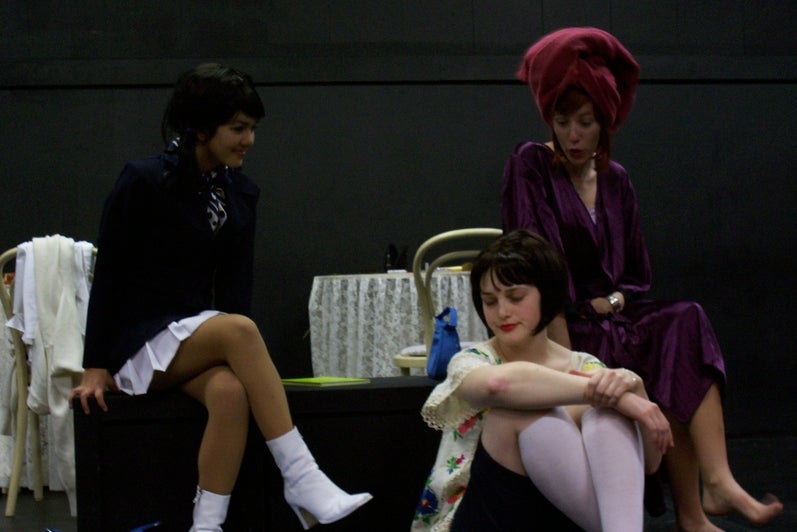 Three women from the play 'New Directions' sitting