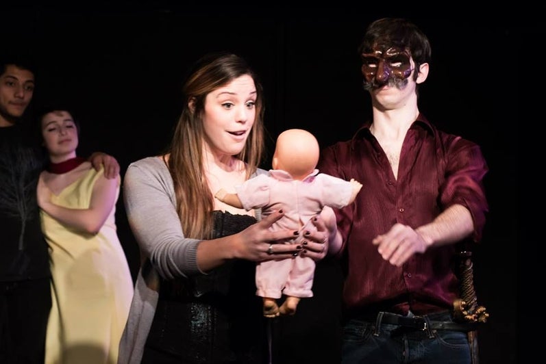 Commedia dell'arte characters hold baby