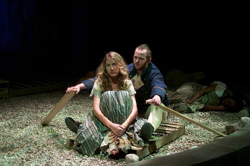 Man and woman sitting down in a makeshift raft