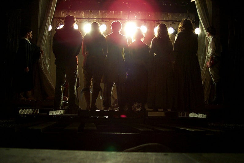 Silhouettes of six people in the play 'Our Country's Good'