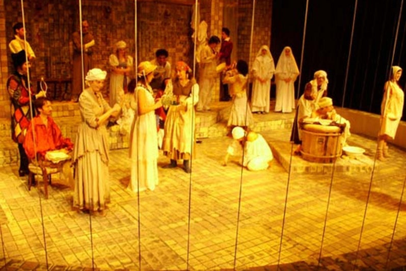 Cast of Marat/Sade performing on stage