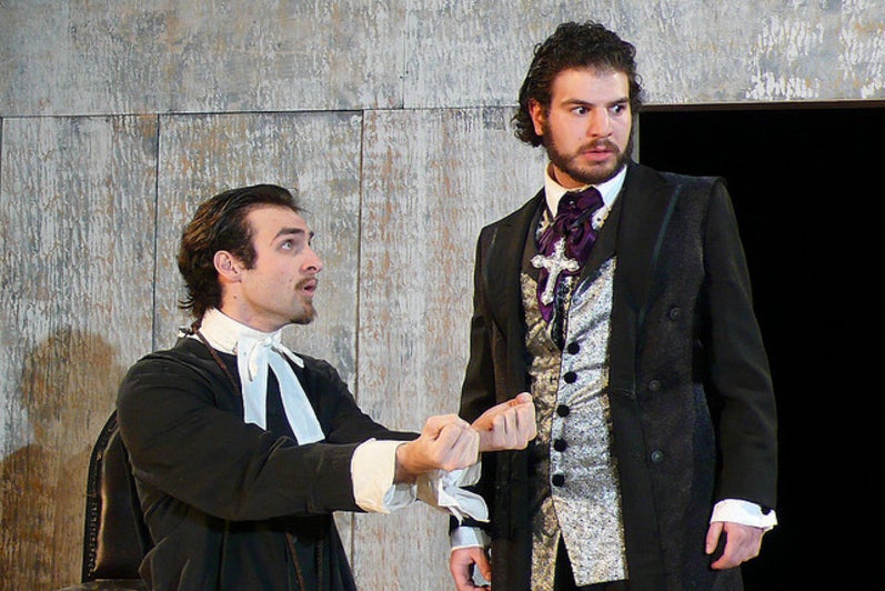 Two men standing in costumes in the play Tartuffe