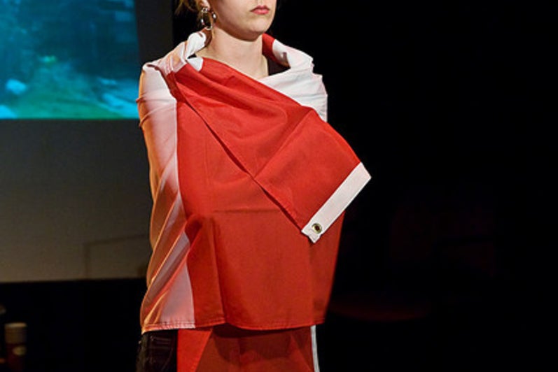 Girl standing wrapped in Canadian flag