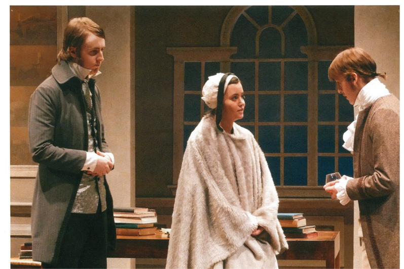 A man in grey coat, one man in a brown coat and a woman in a white cloak