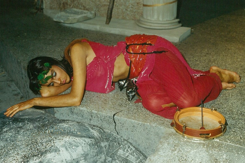 Woman in red outfit laying on the ground asleep