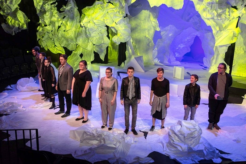 An image of the full cast on stage