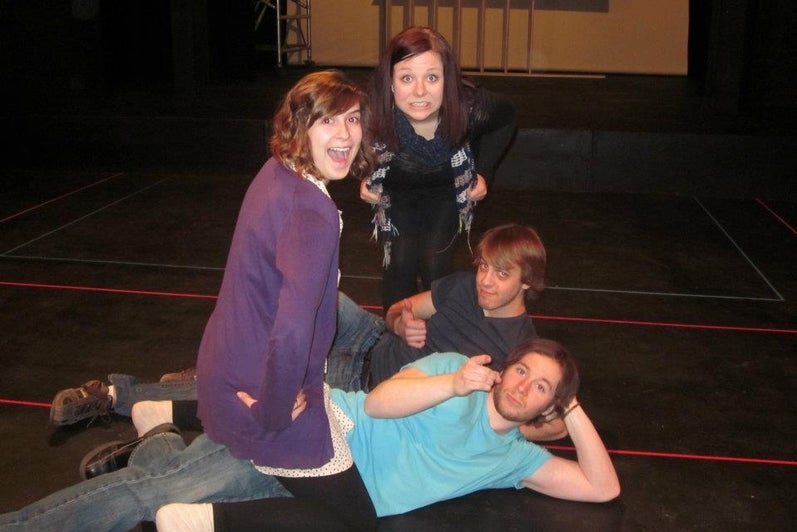 Photo of cast sitting on stage