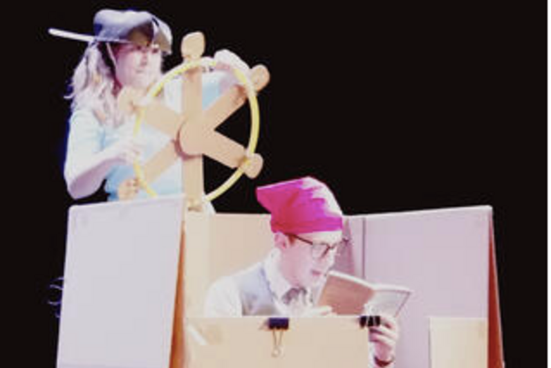 Justin and Olivia play with the boxes on stage