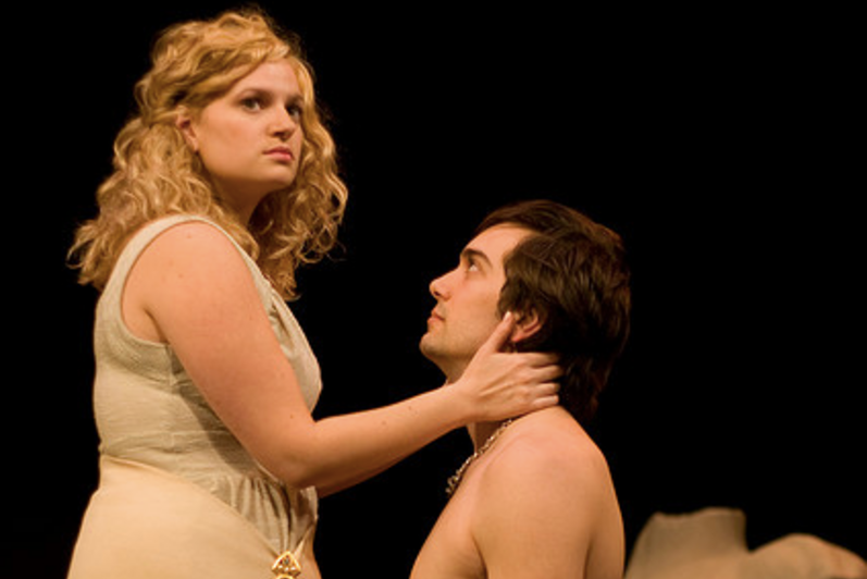 Man kneeling in front of woman in the play 'Julius Caesar'